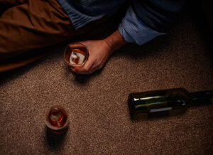 Holding half empty glass of alcoholic drink | ADAPT Programs