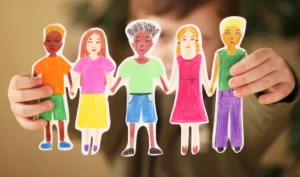 boy holding paper homemade garland of people