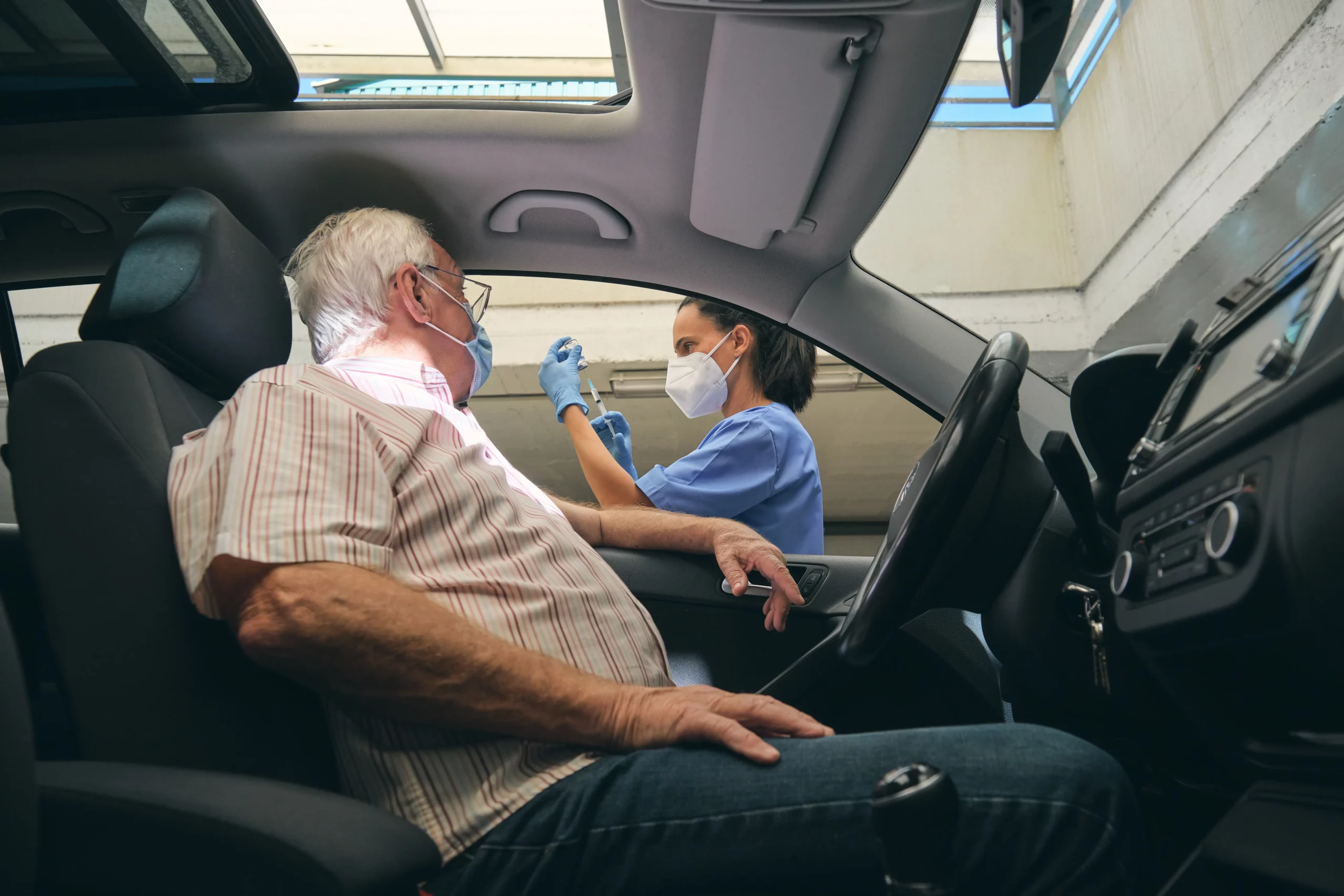crop nurse filling syringe with vaccine