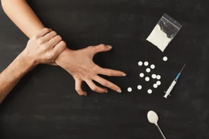drug addict hands on dark table