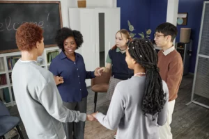 group of teenagers standing in circle holding hand