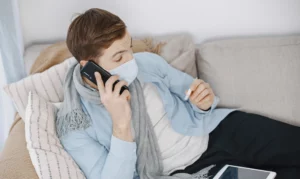 sick man sitting on sofa at home